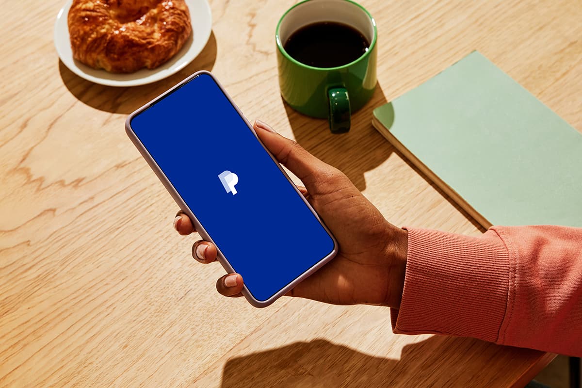 Official PayPal product photography showing the PayPal mobile app and its consumer payment experience.