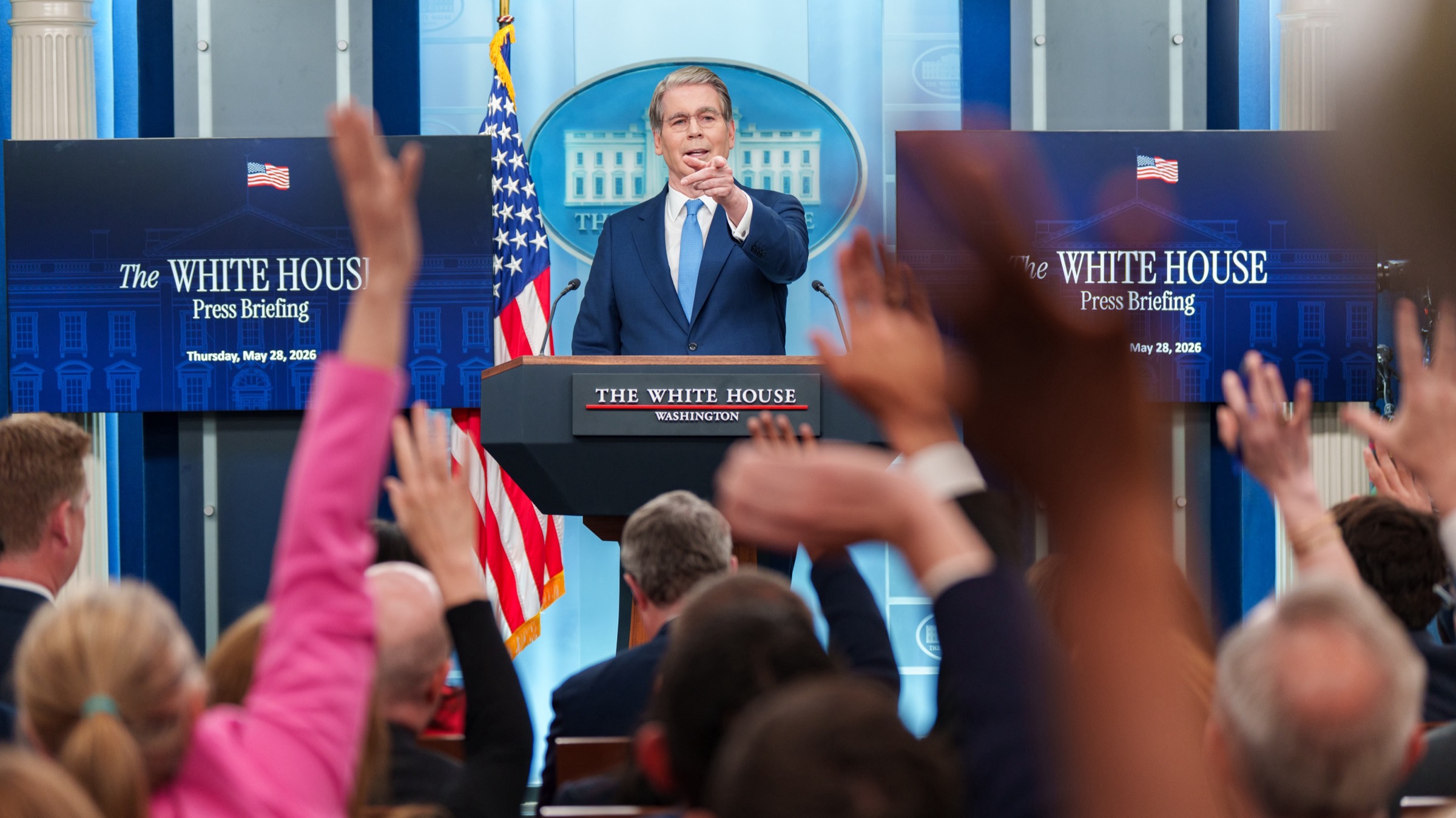 U.S. Treasury Secretary Scott Bessent takes questions from reporters at a White House press briefing lectern.
